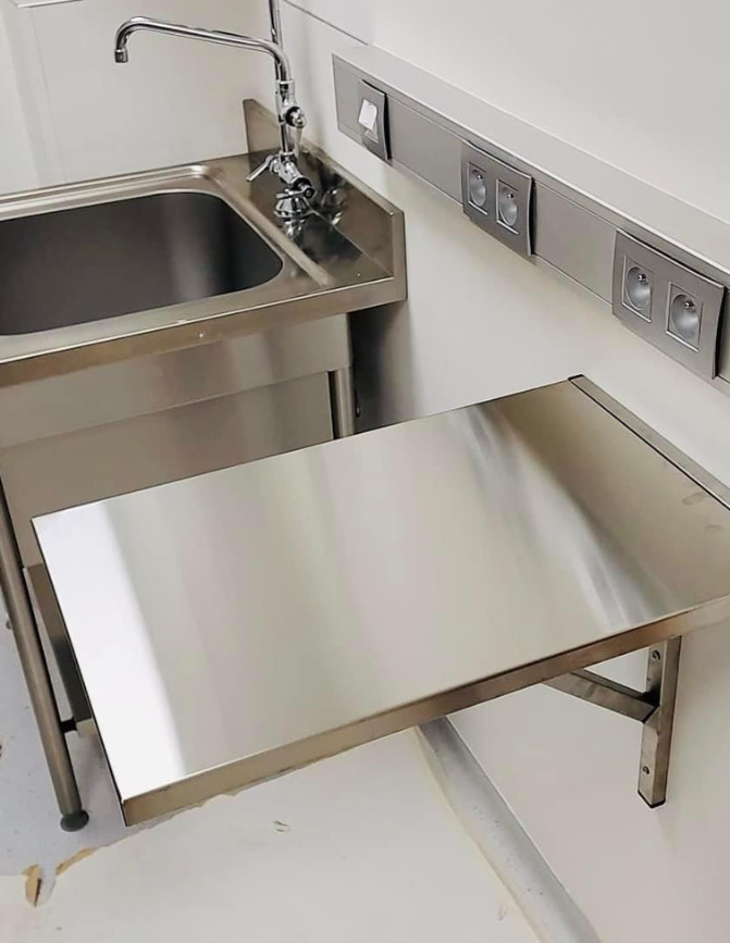 A collection of veterinary tables and sinks